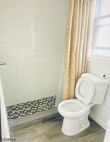 61 Thornall St, Carteret Boro, NJ 07008 - full bathroom featuring a stall shower and toilet