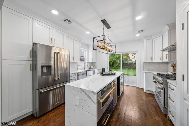 22 Race St, Nutley Twp, NJ 07110 - kitchen with appliances with stainless steel finishes, a center island, tasteful backsplash, white cabinets, and recessed lighting