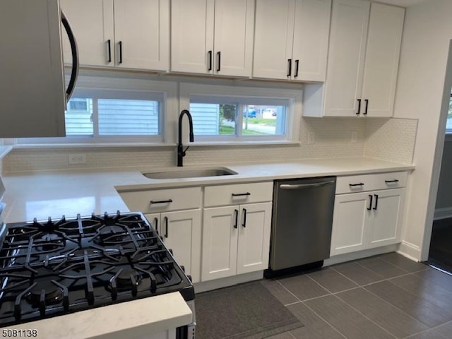 3 Janet Dr, Mine Hill Twp, NJ 07803 - kitchen with stainless steel dishwasher, a sink, backsplash, and light countertops