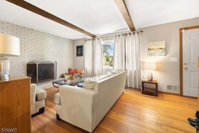 580 Mountainview Dr, North Plainfield Boro, NJ 07063 - living area featuring beamed ceiling, a brick fireplace, light wood-style floors, and baseboards