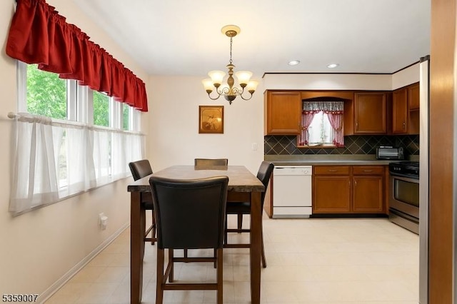 580 Mountainview Dr, North Plainfield Boro, NJ 07063 - kitchen with white dishwasher, stainless steel range oven, a chandelier, backsplash, and baseboards