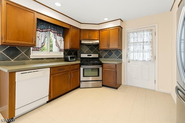 580 Mountainview Dr, North Plainfield Boro, NJ 07063 - kitchen featuring white dishwasher, stainless steel range with gas stovetop, under cabinet range hood, brown cabinetry, and tasteful backsplash