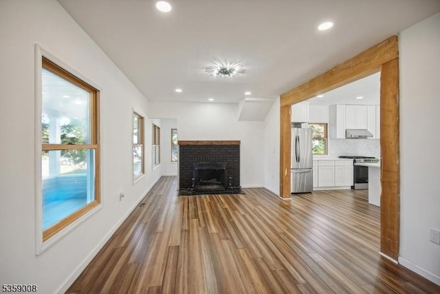 1899 Washington Valley Rd, Bridgewater Twp, NJ 08836 - unfurnished living room featuring wood finished floors, recessed lighting, baseboards, and a fireplace