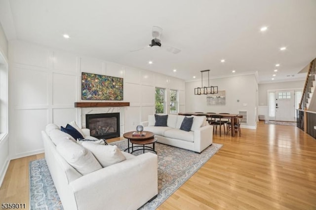 84 Elmwood Ave, Chatham Boro, NJ 07928 - living area featuring a premium fireplace, ceiling fan, light wood-style floors, a decorative wall, and recessed lighting