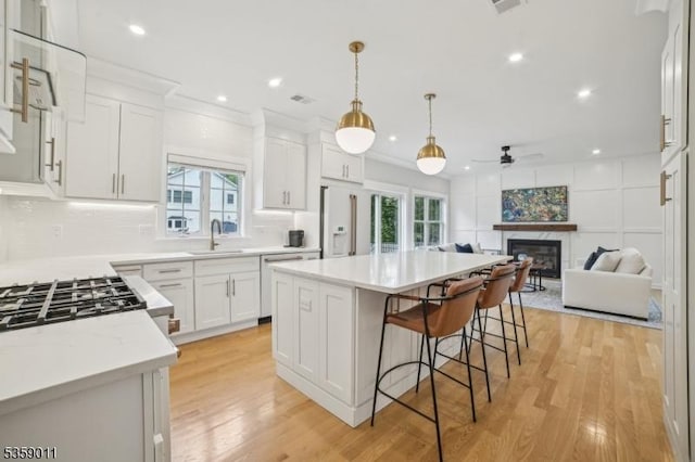 84 Elmwood Ave, Chatham Boro, NJ 07928 - kitchen with a sink, a ceiling fan, a glass covered fireplace, healthy amount of natural light, and recessed lighting