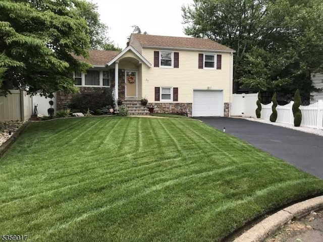 37 Furber Ave, Linden City, NJ 07036 - tri-level home with asphalt driveway, an attached garage, and stone siding