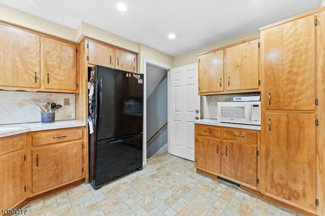 37 Furber Ave, Linden City, NJ 07036 - kitchen with freestanding refrigerator, white microwave, light countertops, recessed lighting, and decorative backsplash