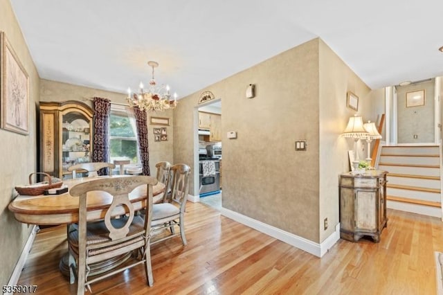 37 Furber Ave, Linden City, NJ 07036 - dining room featuring a chandelier, light wood-type flooring, and stairs