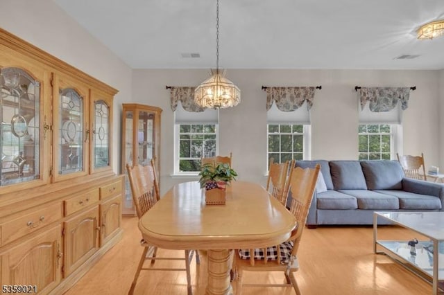 7013 Brookfield Glen Dr, White Twp, NJ 07823 - dining area featuring light wood finished floors, healthy amount of natural light, and a chandelier