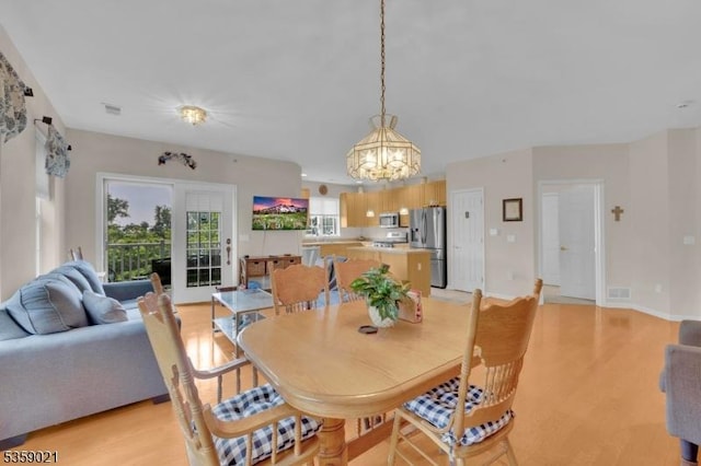 7013 Brookfield Glen Dr, White Twp, NJ 07823 - dining room with a chandelier and light wood finished floors
