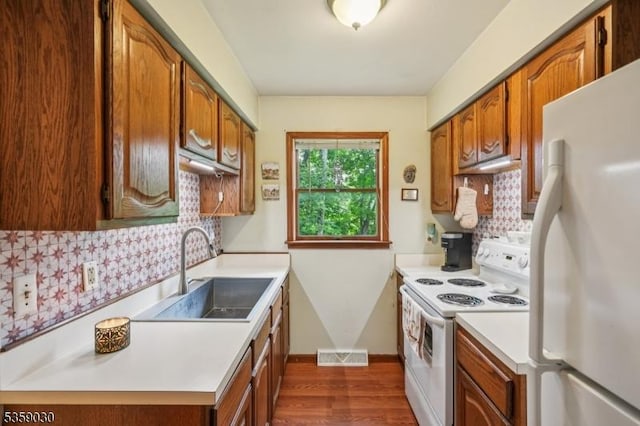 2 Beach Plz, Hardyston Twp, NJ 07460 - kitchen featuring white appliances, light countertops, dark wood finished floors, tasteful backsplash, and brown cabinetry