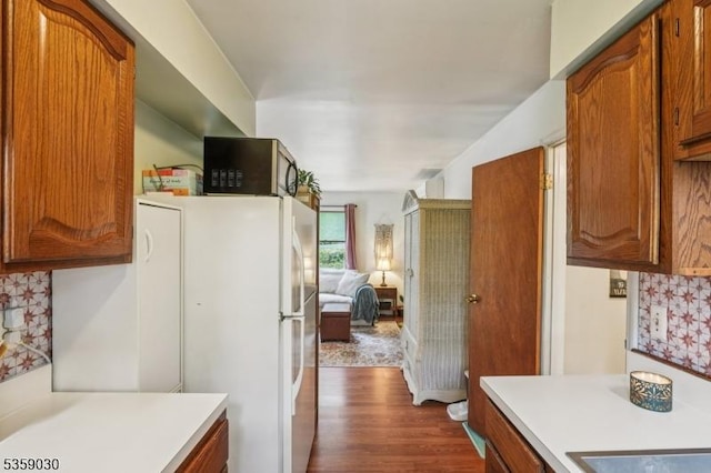 2 Beach Plz, Hardyston Twp, NJ 07460 - kitchen with light countertops, dark wood-style floors, brown cabinets, freestanding refrigerator, and tasteful backsplash