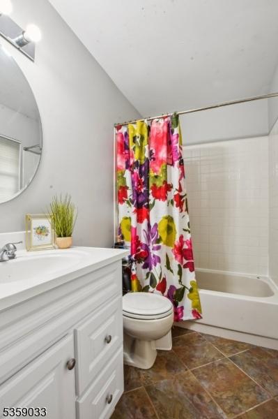 25 Manor Dr, Hillsborough Twp, NJ 08844 - full bath with vanity, toilet, shower / tub combo with curtain, and vaulted ceiling