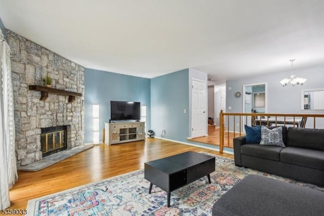 25 Manor Dr, Hillsborough Twp, NJ 08844 - living room featuring wood finished floors, a chandelier, and a stone fireplace