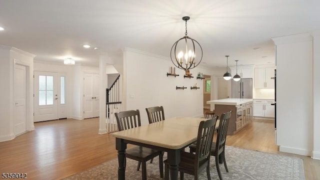 6 Balfour Ln, Scotch Plains Twp, NJ 07076 - dining area featuring light wood-style floors, plenty of natural light, stairway, a chandelier, and ornamental molding