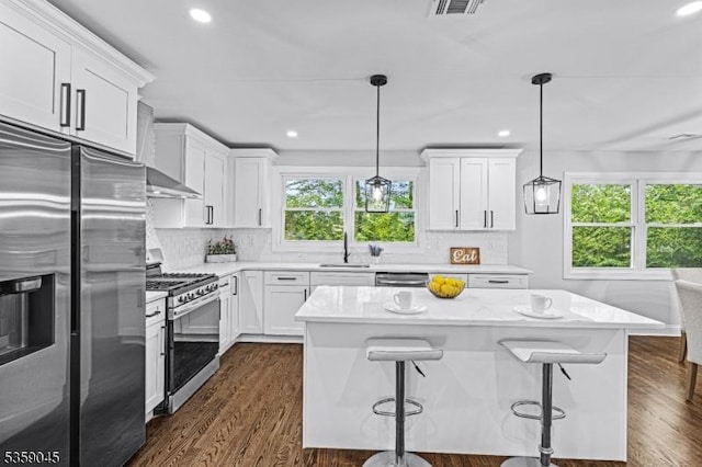 192 Mohawk Trl, Wayne Twp, NJ 07470 - kitchen with stainless steel appliances, a sink, white cabinets, decorative backsplash, and dark wood finished floors