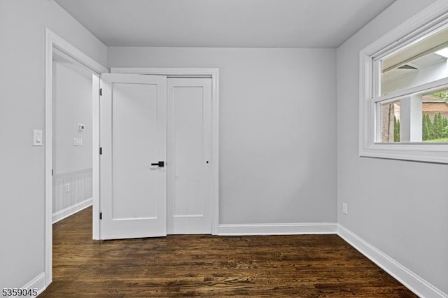192 Mohawk Trl, Wayne Twp, NJ 07470 - unfurnished bedroom with dark wood finished floors, a closet, and baseboards