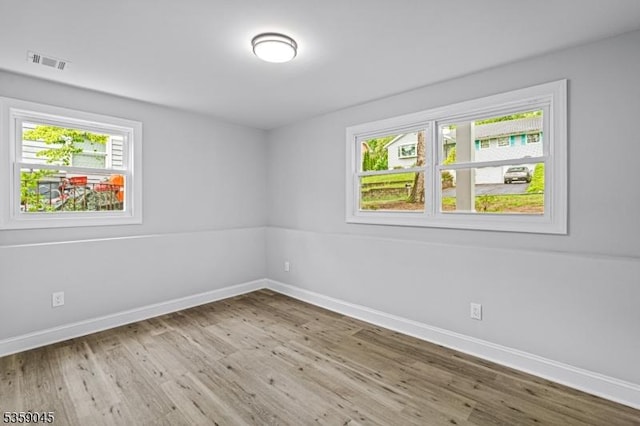 192 Mohawk Trl, Wayne Twp, NJ 07470 - unfurnished room featuring plenty of natural light, wood finished floors, and baseboards