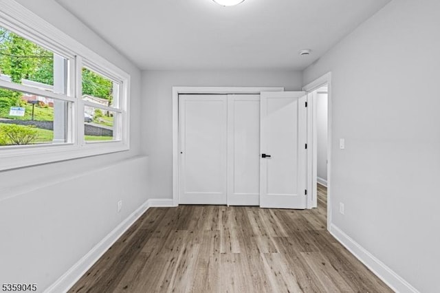 192 Mohawk Trl, Wayne Twp, NJ 07470 - unfurnished bedroom with wood finished floors, baseboards, and a closet
