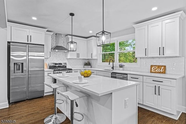 192 Mohawk Trl, Wayne Twp, NJ 07470 - kitchen with appliances with stainless steel finishes, wall chimney range hood, a sink, white cabinetry, and recessed lighting