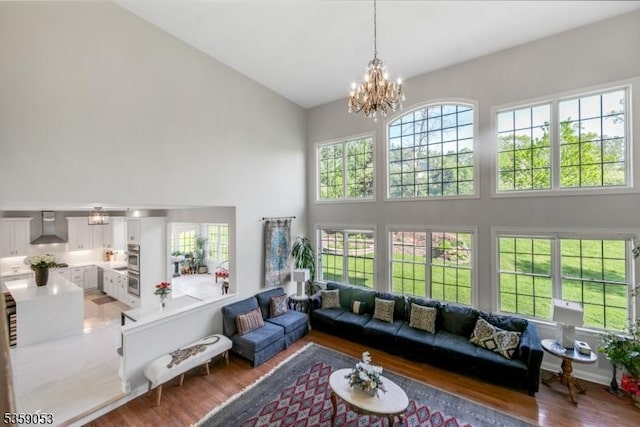 4 Greenbriar Ct, Mount Olive Twp, NJ 07836 - living area with high vaulted ceiling, wood finished floors, and a chandelier