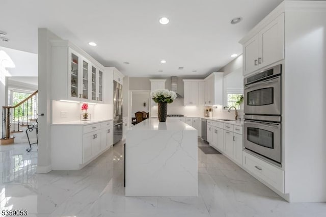 4 Greenbriar Ct, Mount Olive Twp, NJ 07836 - kitchen with stainless steel appliances, a sink, wall chimney range hood, a center island, and glass insert cabinets