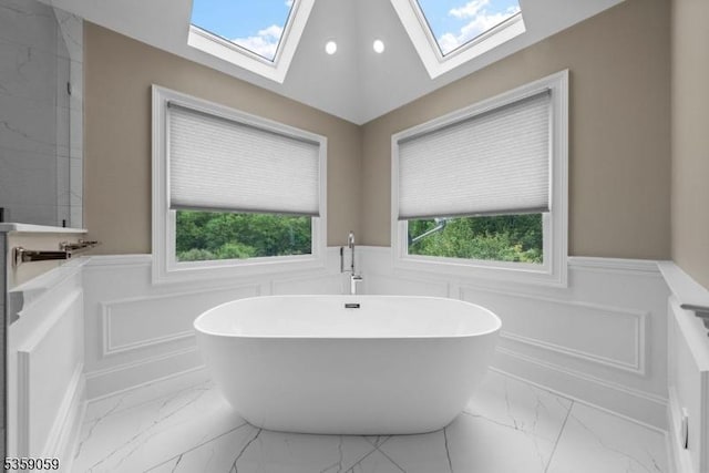 1 Fleming Rd, Tewksbury Twp, NJ 07830 - bathroom with a wainscoted wall, marble finish flooring, a soaking tub, a decorative wall, and a skylight