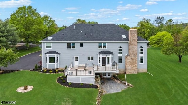 1 Fleming Rd, Tewksbury Twp, NJ 07830 - rear view of property with a chimney, a deck, and a lawn