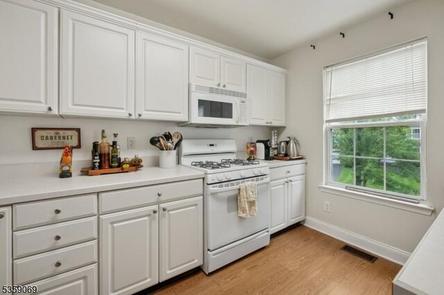 5 Prescott Ct, Condo, Bernards Twp, NJ 07920 - kitchen featuring white appliances, white cabinets, and light wood-type flooring