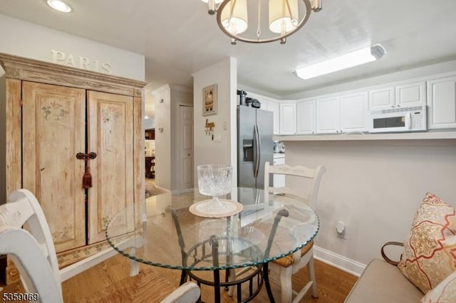5 Prescott Ct, Condo, Bernards Twp, NJ 07920 - dining area featuring baseboards, wood finished floors, and a chandelier