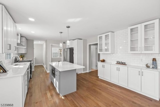 231 Sutphin Ln, Hillsborough Twp, NJ 08844 - kitchen featuring stainless steel appliances, decorative backsplash, light wood-type flooring, white cabinets, and recessed lighting