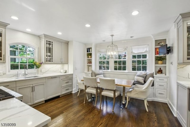 42 Haddonfield Rd, Millburn Twp, NJ 07078 - kitchen featuring a sink, dark wood-type flooring, recessed lighting, decorative light fixtures, and light stone counters