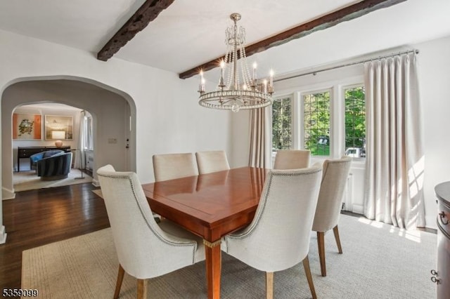 42 Haddonfield Rd, Millburn Twp, NJ 07078 - dining space featuring arched walkways, beam ceiling, wood finished floors, and a chandelier