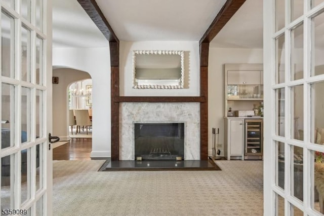 42 Haddonfield Rd, Millburn Twp, NJ 07078 - living room with beverage cooler, arched walkways, french doors, and a chandelier