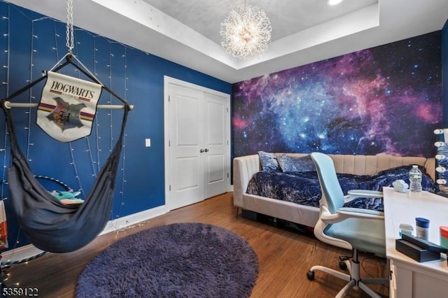 12-64 Orchard St, Fair Lawn Boro, NJ 07410 - bedroom featuring wood finished floors, a tray ceiling, an accent wall, a chandelier, and baseboards