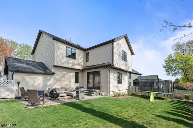 12-64 Orchard St, Fair Lawn Boro, NJ 07410 - back of property featuring a trampoline, a patio area, and a gate