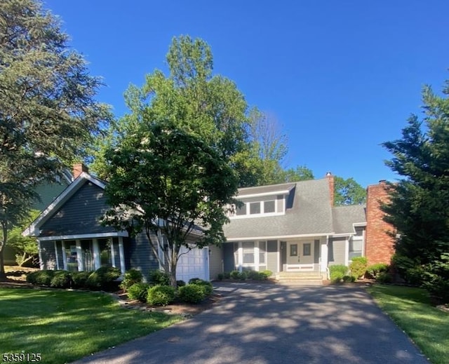 19 Gatehouse Rd, Bedminster Twp, NJ 07921 - view of front of house with asphalt driveway, an attached garage, a front lawn, and a chimney