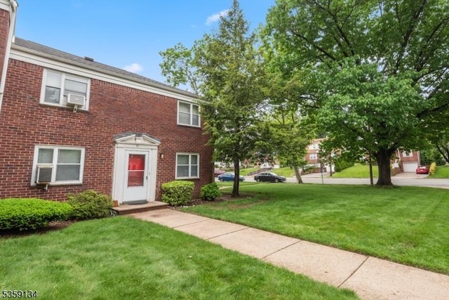 465 Maple Hill Dr Unit 51, Hackensack City, NJ 07601 - colonial inspired home featuring brick siding, a front yard, and cooling unit