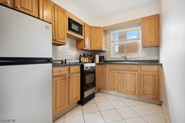 465 Maple Hill Dr Unit 51, Hackensack City, NJ 07601 - kitchen with freestanding refrigerator, range with gas cooktop, black microwave, dark countertops, and backsplash