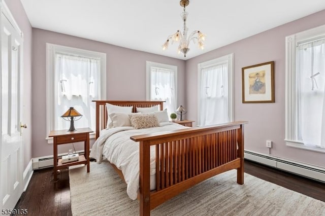 457 Academy St, South Orange Village Twp, NJ 07079 - bedroom featuring a chandelier, wood finished floors, a baseboard radiator, and baseboards