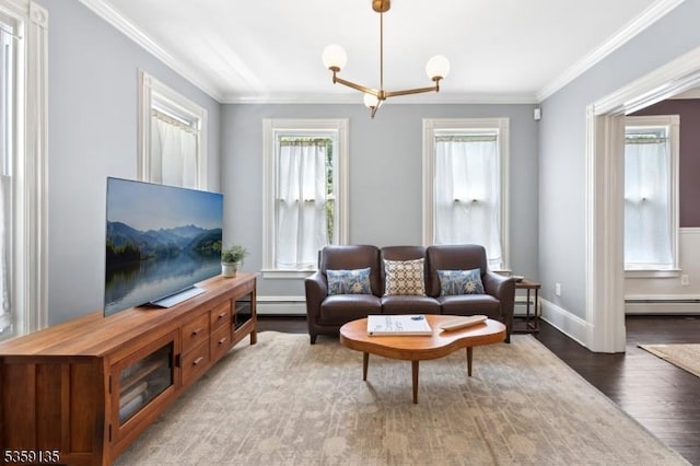 457 Academy St, South Orange Village Twp, NJ 07079 - living room with a chandelier, a baseboard heating unit, wood finished floors, ornamental molding, and baseboards