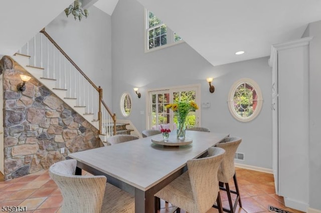60 Dogwood Ln, Montgomery Twp, NJ 08558 - dining space with stairway, light tile patterned floors, baseboards, and a towering ceiling