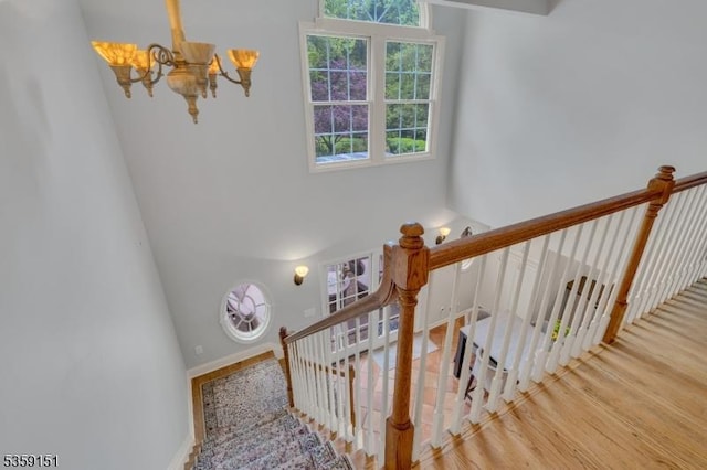 60 Dogwood Ln, Montgomery Twp, NJ 08558 - staircase with a chandelier, a towering ceiling, and wood finished floors