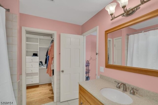 60 Dogwood Ln, Montgomery Twp, NJ 08558 - full bath with vanity, a walk in closet, a chandelier, and tile patterned floors