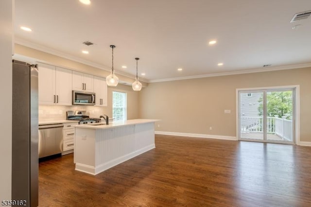 2000 Whittier St, Rahway City, NJ 07065 - kitchen featuring appliances with stainless steel finishes, a center island with sink, crown molding, white cabinets, and dark wood-style floors
