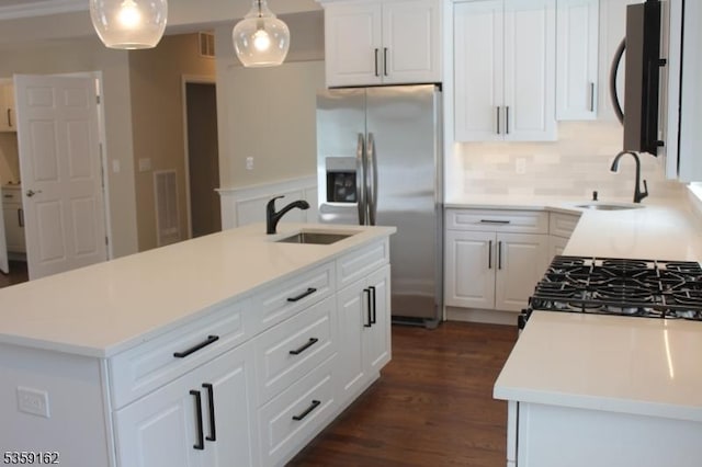 2000 Whittier St, Rahway City, NJ 07065 - kitchen with stainless steel fridge, a sink, white cabinets, and decorative backsplash