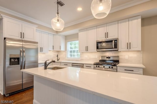 2000 Whittier St, Rahway City, NJ 07065 - kitchen with appliances with stainless steel finishes, a sink, ornamental molding, light countertops, and white cabinetry