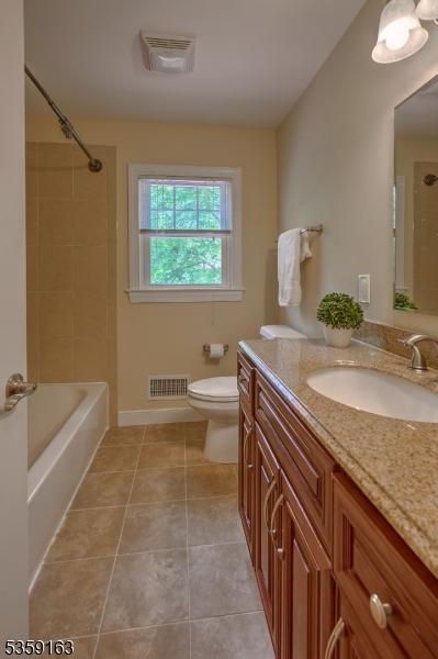 41 Lake Rd, Bernards Twp, NJ 07920 - bathroom featuring vanity, toilet, tile patterned flooring, and shower / bath combination