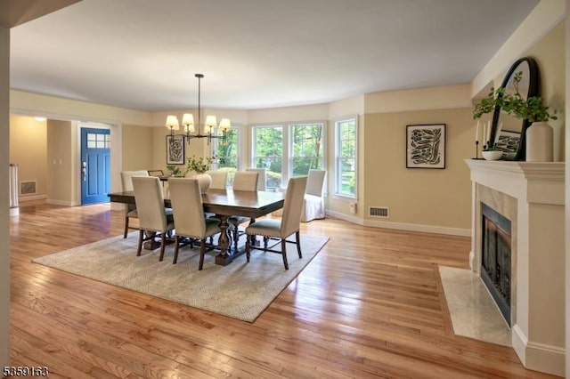 41 Lake Rd, Bernards Twp, NJ 07920 - dining area featuring a fireplace with flush hearth, plenty of natural light, light wood-type flooring, and baseboards
