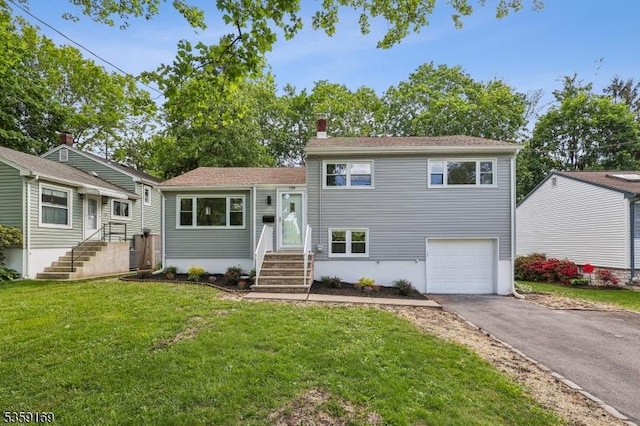 158 Old Indian Rd, West Orange Twp, NJ 07052 - split level home featuring driveway, a garage, a front yard, and a chimney